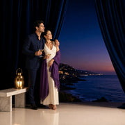 Couple sharing champagne by lantern light above a dusk coastline, Iconic Bucketlist Luxe experience gift