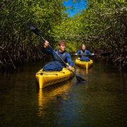 Two paddlers in yellow kayaks gliding through a mangrove tunnel, Mangrove Kayak Tour experience gift