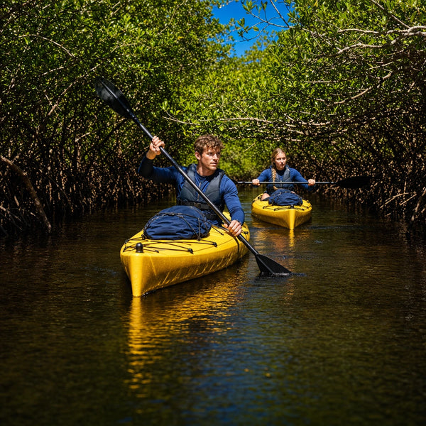 Two paddlers in yellow kayaks gliding through a mangrove tunnel, Mangrove Kayak Tour experience gift