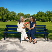 Daughter giving her mother tulips on a park bench, Mother's Day in New York City Experience Collection gift