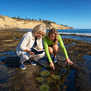 Mother and daughter finding a sea anemone at a tide pool, Mother's Day in San Diego Experience Collection gift