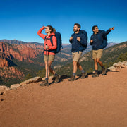 Three friends hiking a ridge trail toward distant peaks, Multi-Day Adventure Tour experience gift