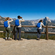 Four travelers taking in a vast forested valley from a granite overlook, Multi-Day National Park Tour experience gift