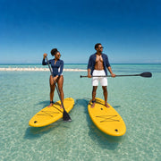 Two paddleboarders gliding over a clear sunlit sandbar, Paddleboarding experience gift