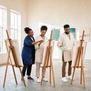 Instructor guiding a student's brushstroke at studio easels, Painting Classes experience gift