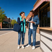 Guide and visitor comparing folded slices at a sidewalk stop, Pizza Tour experience gift