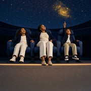 Mother and kids reclining under a glowing planetarium dome, Planetarium Show experience gift