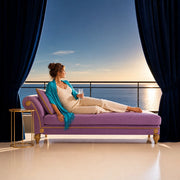 Woman lounging on a chaise with sparkling water on a sea-view balcony, Iconic Treat Yourself experience gift
