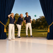 Family playing evening bocce on a park lawn as the father tosses the ball, Iconic Family Time experience gift
