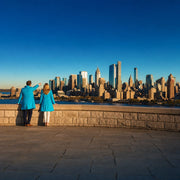 Two small figures at a stone overlook wall, one pointing to the skyline, Iconic Must-See Sights experience gift