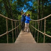 Guide pointing out a bird from a rope bridge high in the rainforest canopy, Rainforest Eco Tour experience gift