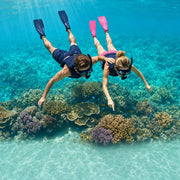 Couple snorkeling above a bright coral reef in turquoise water, Reef & Coral Snorkeling experience gift