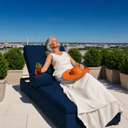 Woman resting on a rooftop garden lounger with iced tea, Washington DC Relaxing Experience Collection experience gift
