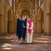 Guide and visitor gazing up at a vaulted stone nave, Religious & Spiritual Tours experience gift