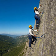 Couple climbing via ferrata rungs up a granite cliff, Rock Climbing & Via Ferrata experience gift