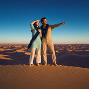 Couple on a dune crest overlooking golden sand at sunset, Sahara Desert Tour experience gift