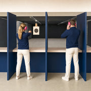 Woman sighting a paper target at an indoor range lane, Shooting Ranges experience gift