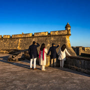 Guide leading visitors along the ramparts of a historic stone fort, History relived experience gift