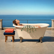 Woman soaking in a clawfoot tub on a sunny sea-view terrace, Spa Bliss experience gift