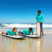 Instructor teaching two students the pop-up on surfboards in the shallows, Surfing Lessons experience gift