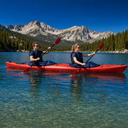 Two paddlers in a red tandem kayak crossing a clear alpine lake, Tandem Kayak experience gift
