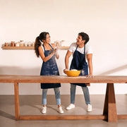 Two friends dusted in flour laughing at a cooking bench, Together Experience Collection experience gift