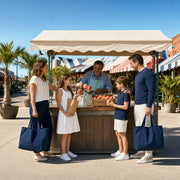 Family buying peaches from a vendor at a sunny open-air market, Houston Together Experience Collection experience gift