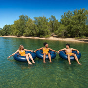 Three friends floating a lazy river in tubes past tree-lined banks, Tubing & Float Trips experience gift