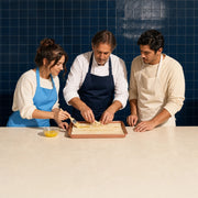 Instructor folding phyllo as his student brushes on melted butter, Turkish Cooking Class experience gift