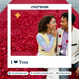 Everwow I love You experience gift card: couple sitting on a red pier covered in rose petals