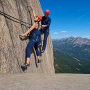 Guide and climber clipped to a cable route on a granite rock face, Via Ferrata Climbing experience gift